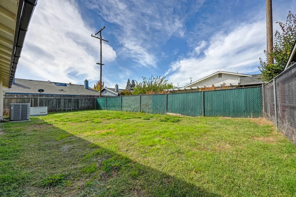 Fenced backyard and lawn at 10229 S White Rock Rd