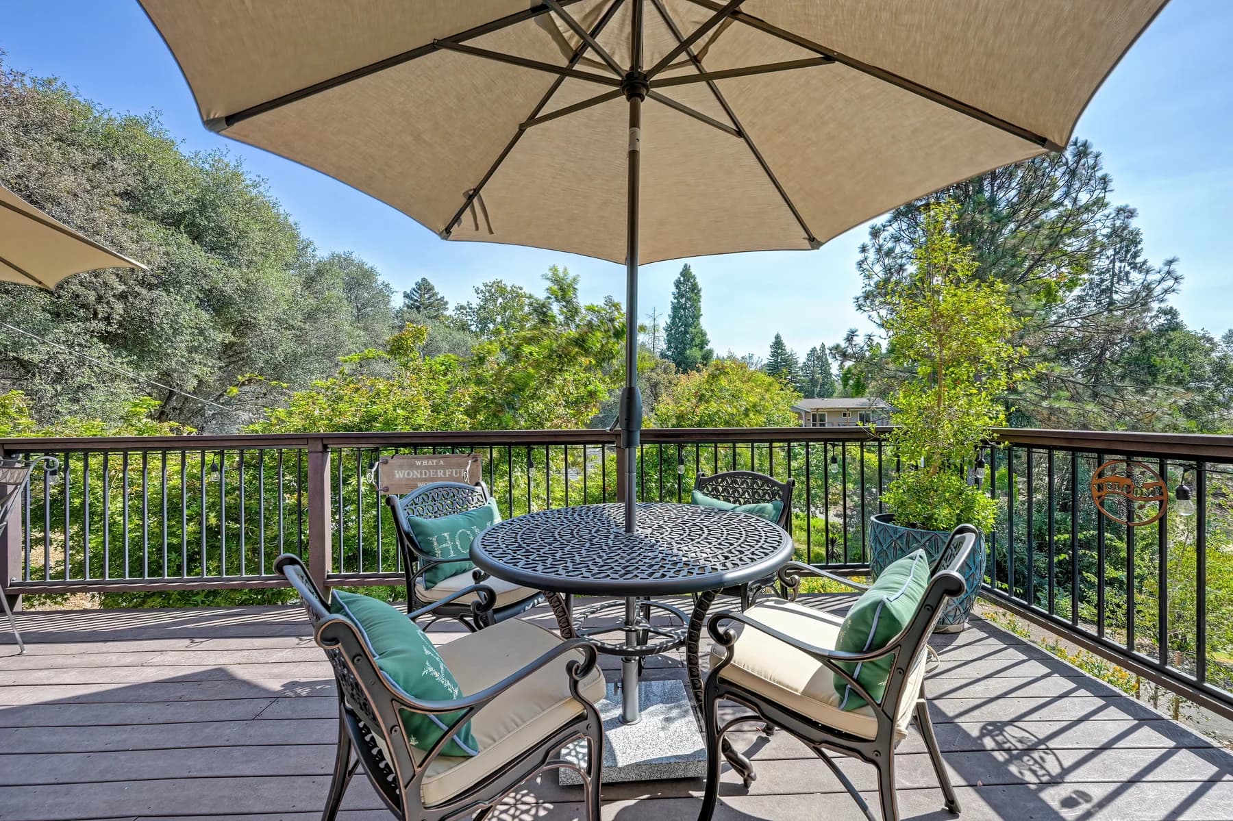 Porch seating with table, umbrella and tree outlook at 153 Russell Rd, Auburn
