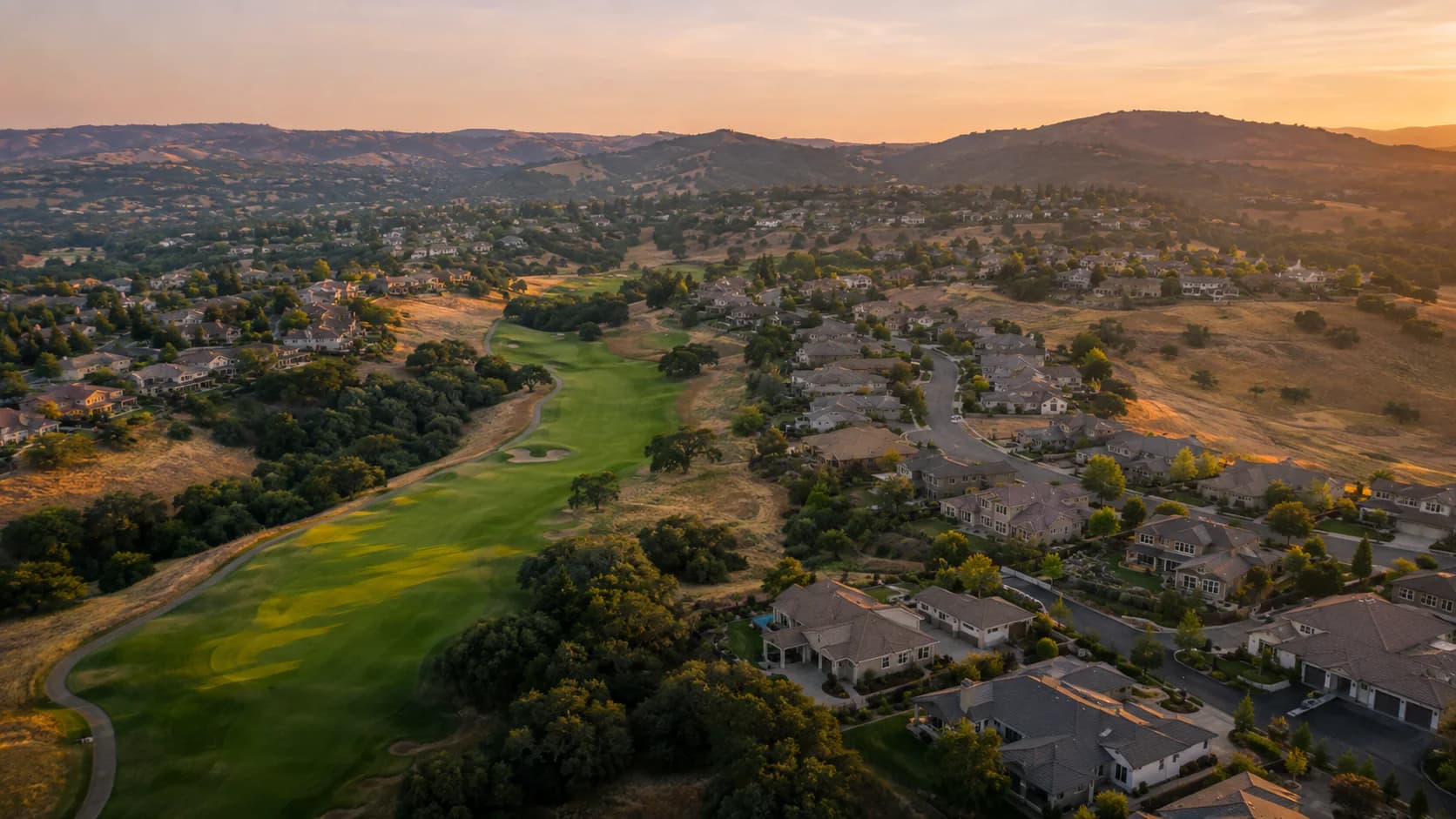 Representative Empire Ranch-style homes following a public golf course in the Folsom foothills