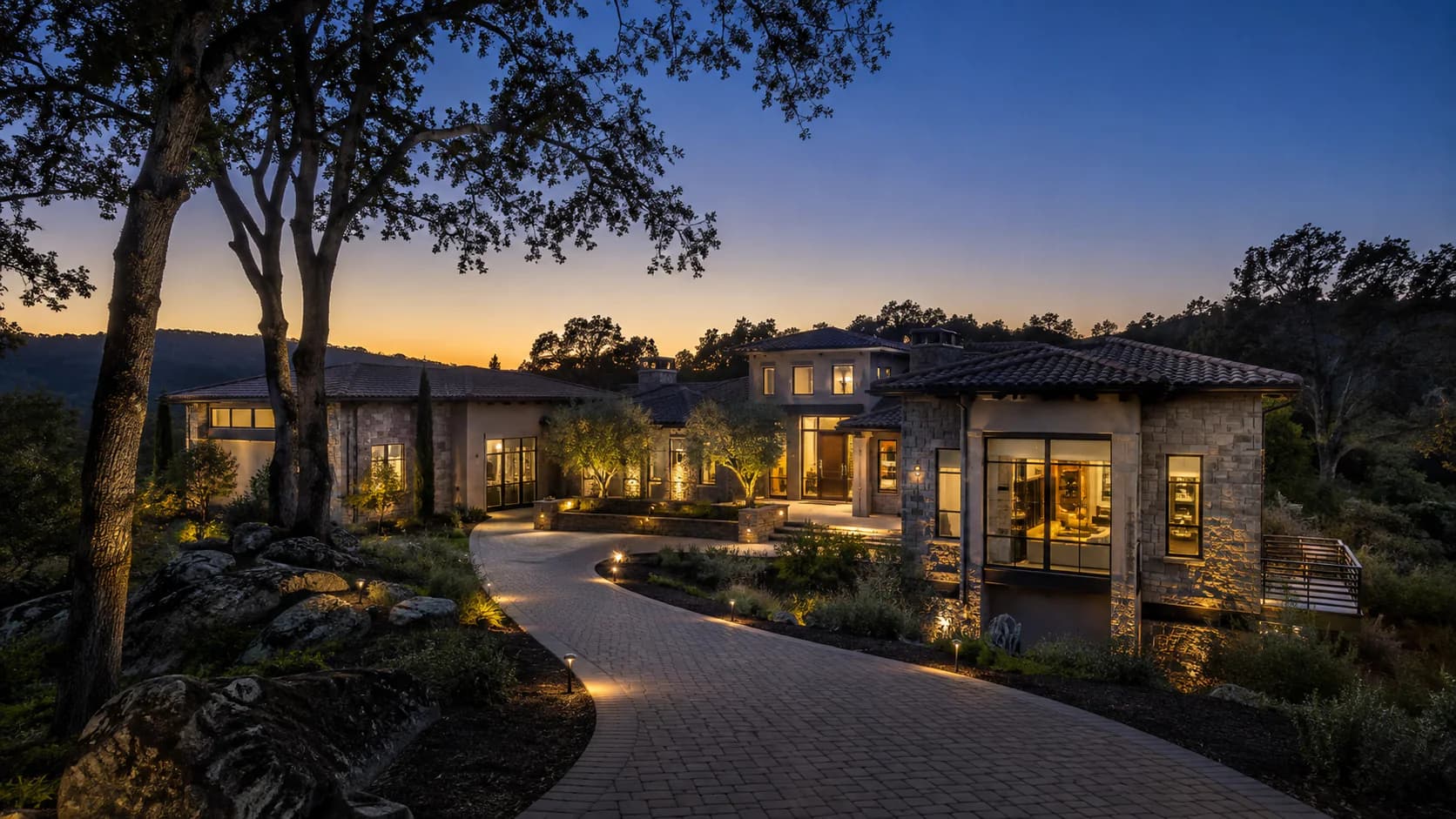 Representative custom estate among mature oaks and granite outcroppings in Granite Bay