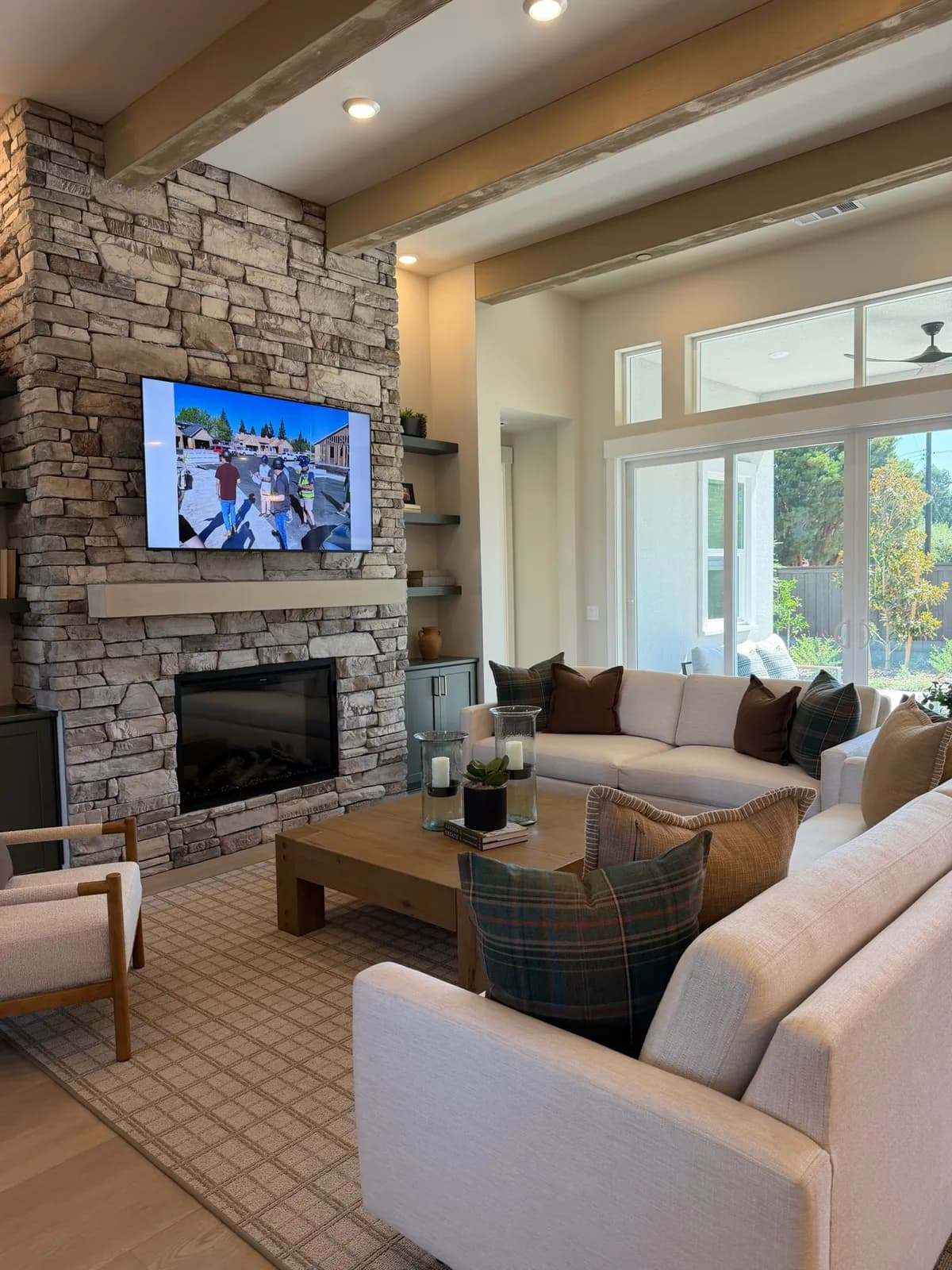 Blossom Ridge model-home great room with stone fireplace and large windows
