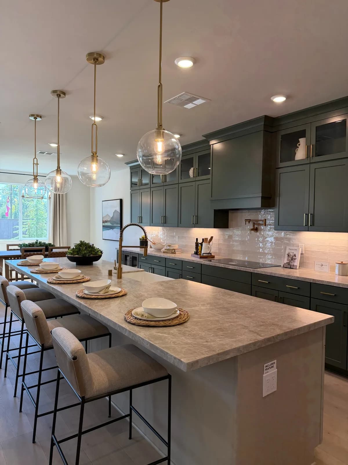 Blossom Ridge model-home kitchen with green cabinets and oversized island