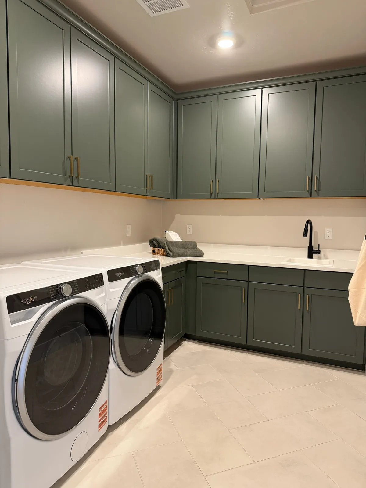 Blossom Ridge model-home laundry room with built-in cabinetry