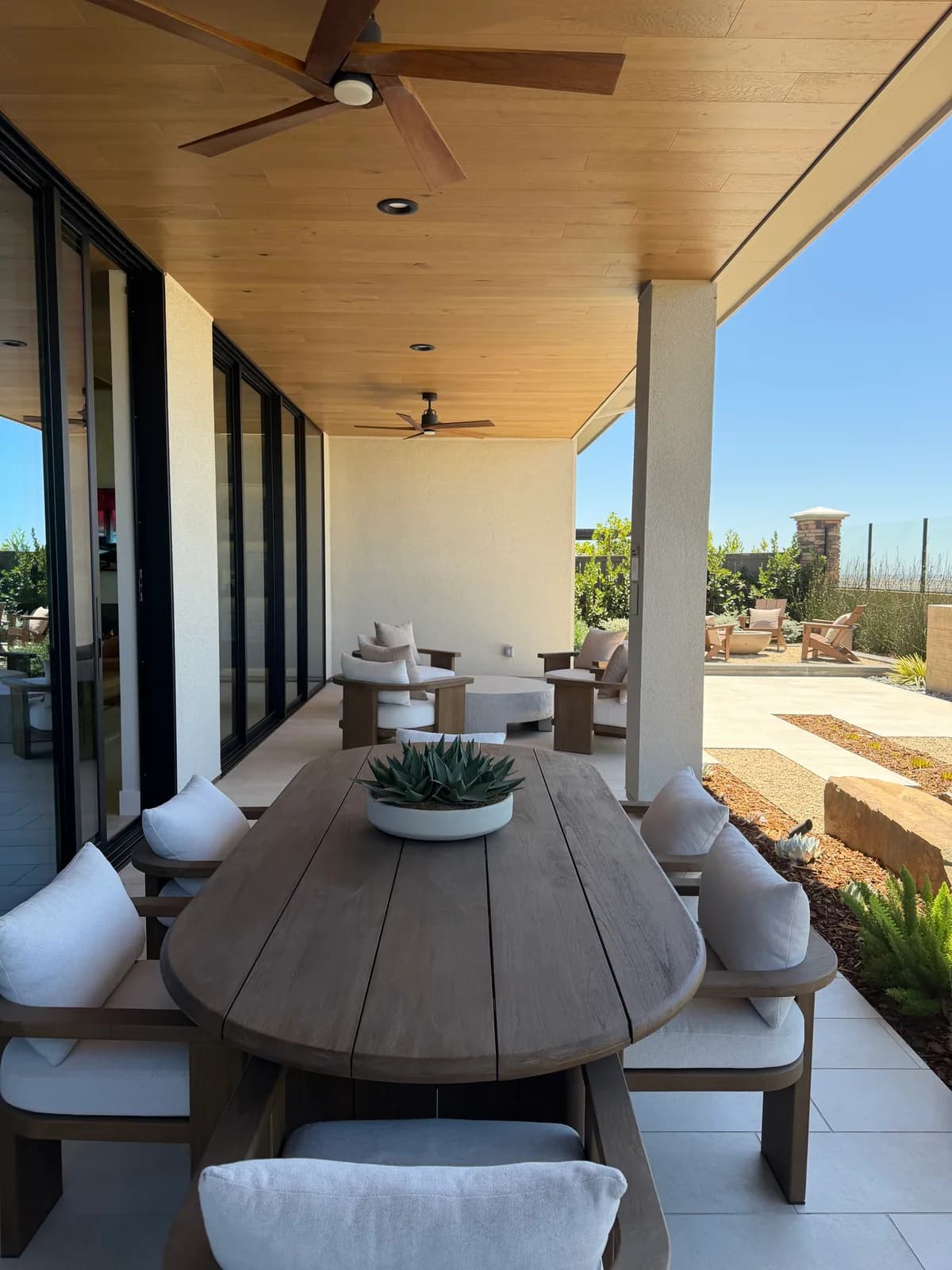 Covered patio connected to a SHAWOOD at Folsom model home by full-height glass doors
