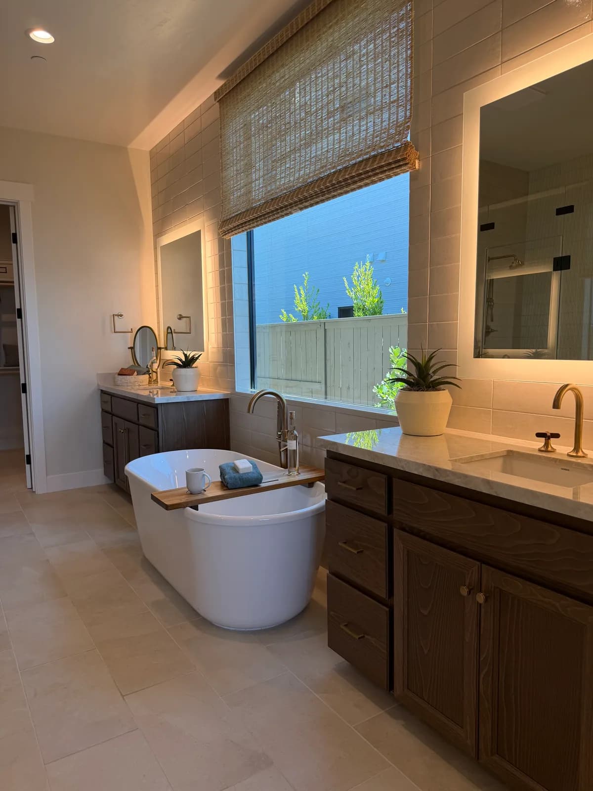 Primary bathroom in a SHAWOOD at Folsom model home with a soaking tub and dual vanity