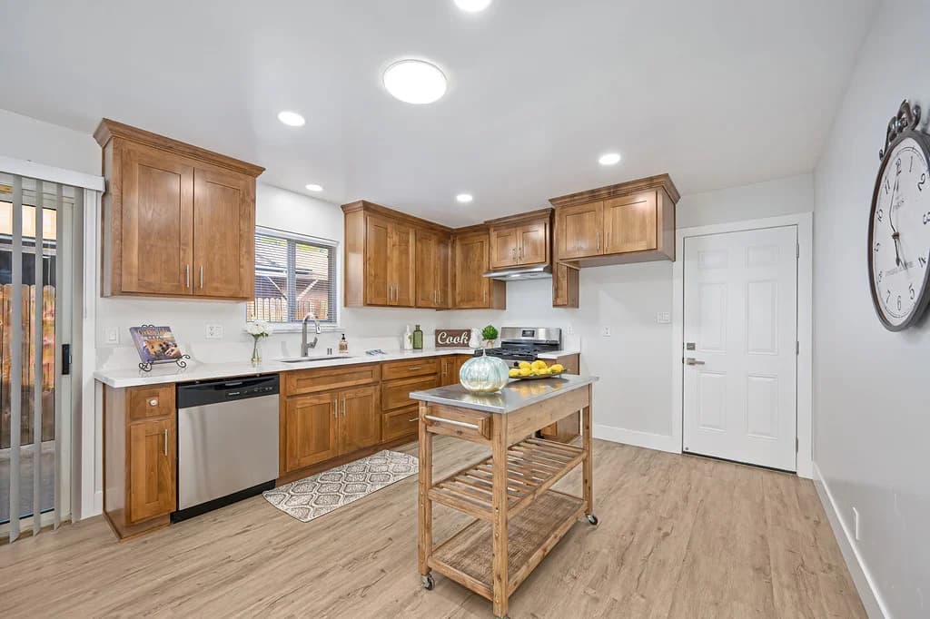 Kitchen with wood-tone cabinets and light countertops at 10229 S White Rock Rd